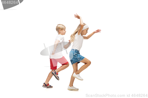 Image of Happy little caucasian girl and boy jumping and running isolated on white background