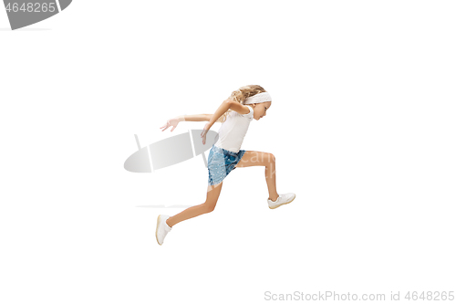 Image of Happy little caucasian girl jumping and running isolated on white background