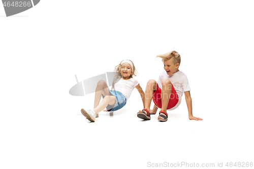 Image of Happy little caucasian girl and boy jumping and running isolated on white background