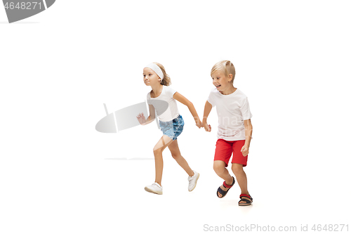 Image of Happy little caucasian girl and boy jumping and running isolated on white background