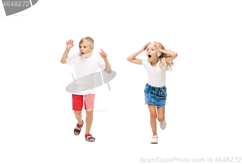 Image of Happy little caucasian girl and boy jumping and running isolated on white background