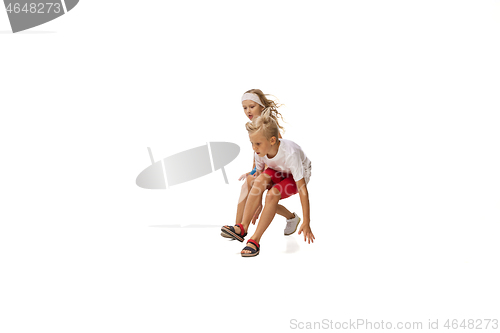 Image of Happy little caucasian girl and boy jumping and running isolated on white background