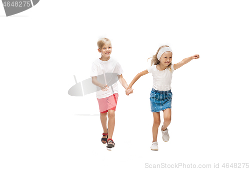 Image of Happy little caucasian girl and boy jumping and running isolated on white background