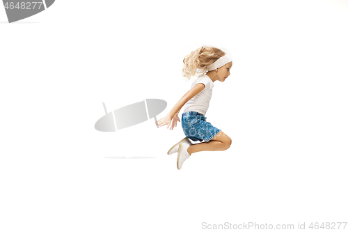 Image of Happy little caucasian girl jumping and running isolated on white background