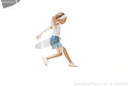 Image of Happy little caucasian girl jumping and running isolated on white background