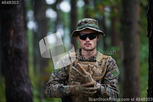 Image of soldier preparing tactical and commpunication gear for action ba