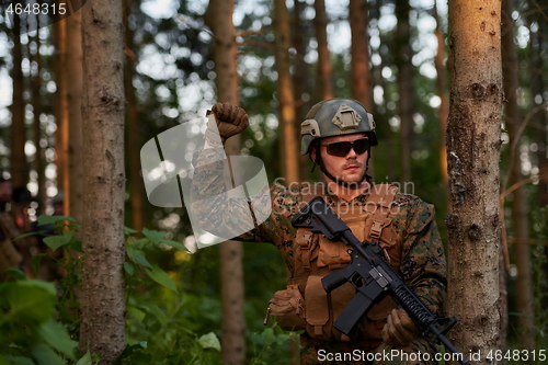 Image of officer is  showing tactical hand signals