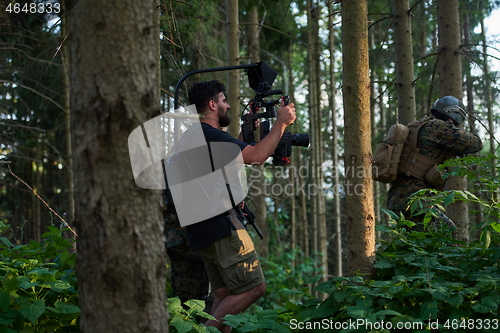 Image of Videographer Taking Action Shoot of Soldiers in Action