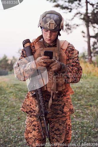 Image of soldier using smart phone