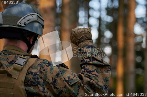 Image of officer is  showing tactical hand signals