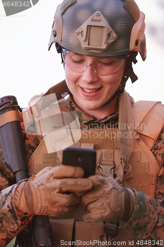 Image of soldier using smart phone