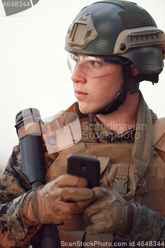 Image of soldier using smart phone