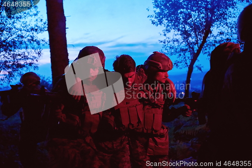 Image of military squad in action rescue wounded soldier