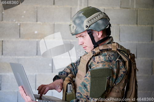 Image of soldier using laptop computer