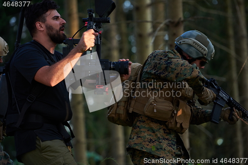 Image of Videographer Taking Action Shoot of Soldiers in Action