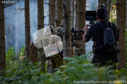 Image of Videographer Taking Action Shoot of Soldiers in Action