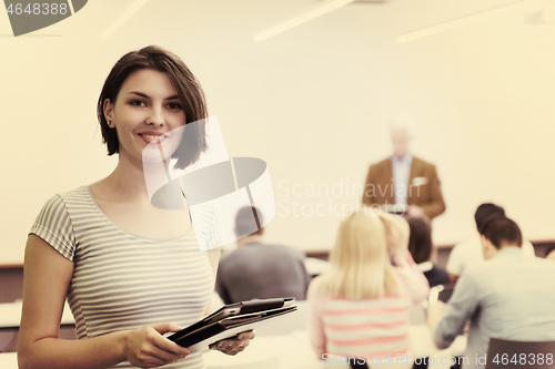 Image of portrait of happy female student in classroom