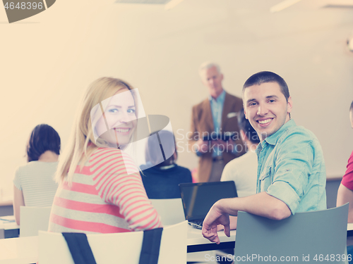 Image of teacher with a group of students in classroom