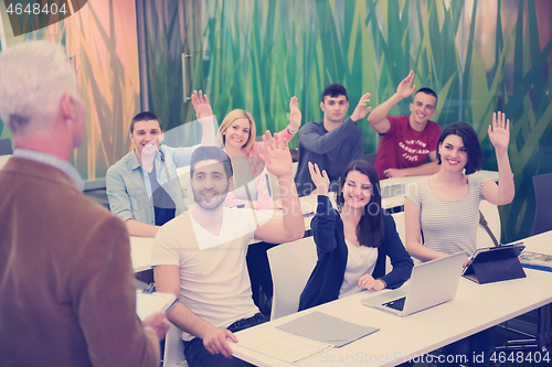 Image of teacher with a group of students in classroom