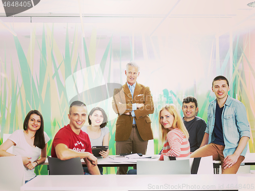 Image of portrait of in teacher in classroom with students group in backg