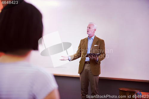 Image of teacher with a group of students in classroom