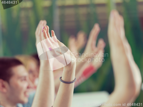 Image of students group raise hands up on class