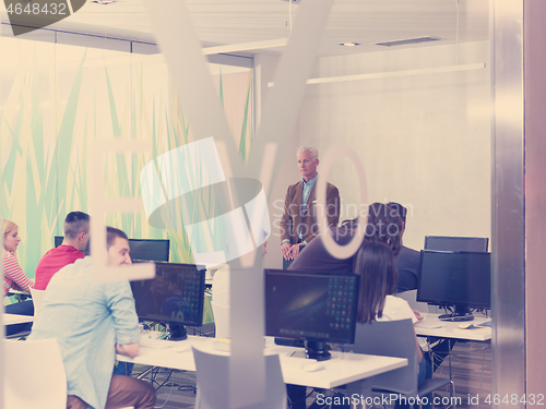 Image of senior teacher and students group in computer lab classroom