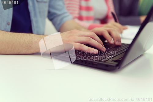 Image of close up of student hands typing on laptop