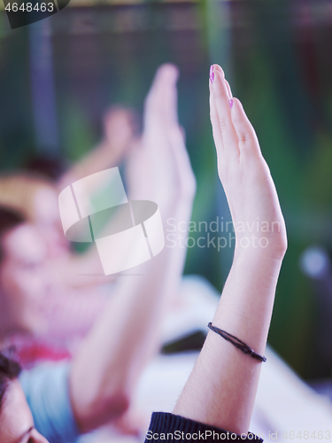 Image of students group raise hands up on class