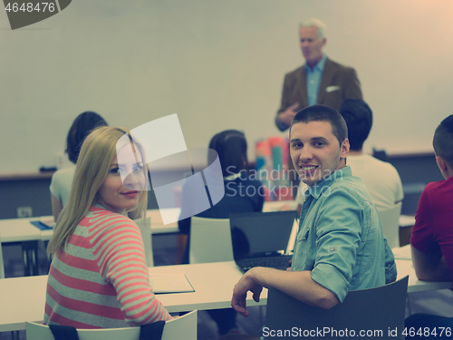 Image of teacher with a group of students in classroom