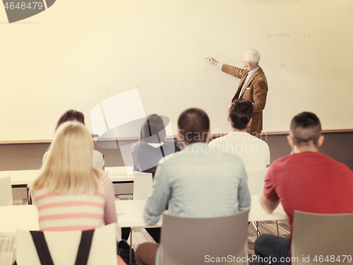 Image of teacher with a group of students in classroom