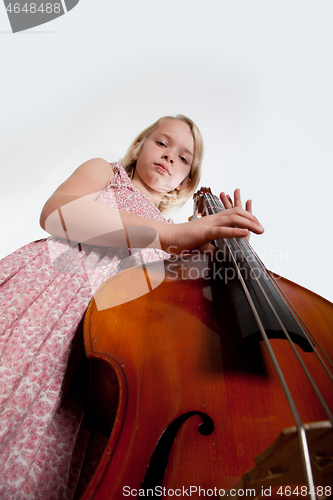 Image of Portrait of a young teenager girl in studio with a cello