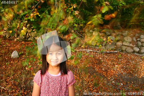 Image of Portrait of a young cute girl looking at the camera outdoor