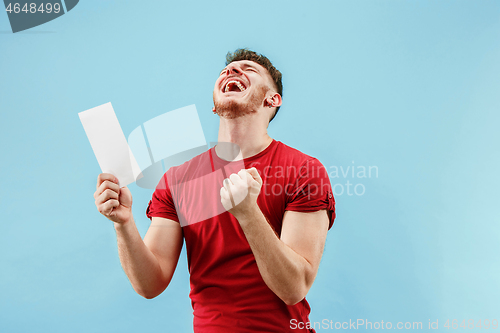 Image of Young boy with a surprised expression bet slip on blue background