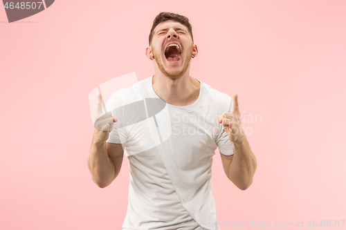 Image of Winning success man happy ecstatic celebrating being a winner. Dynamic energetic image of male model