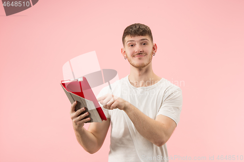 Image of portrait of smiling man pointing at laptop with blank screen isolated on white