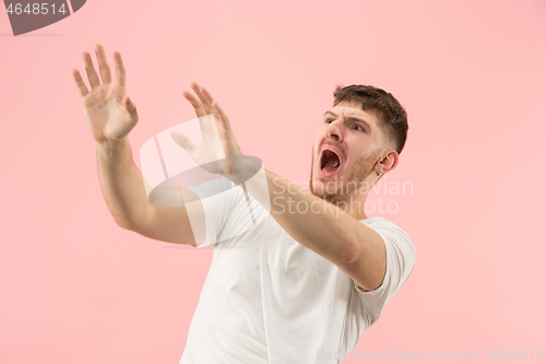 Image of Portrait of the scared man on pink