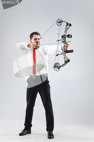 Image of Businessman aiming at target with bow and arrow, isolated on white background