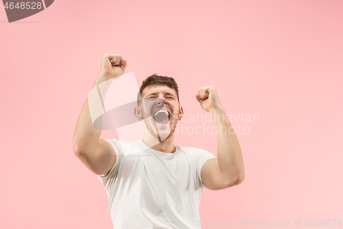 Image of Winning success man happy ecstatic celebrating being a winner. Dynamic energetic image of male model