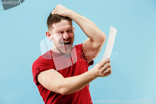 Image of Young boy with a surprised expression bet slip on blue background