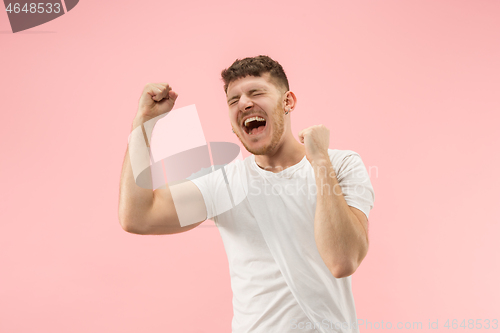 Image of Winning success man happy ecstatic celebrating being a winner. Dynamic energetic image of male model