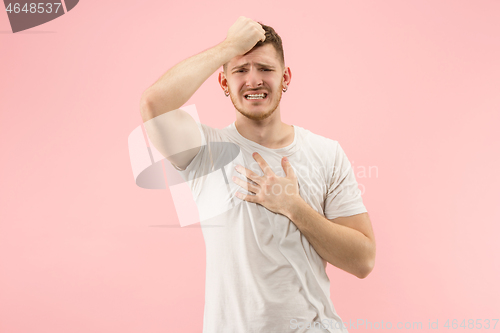 Image of Beautiful man looking suprised and bewildered isolated on pink