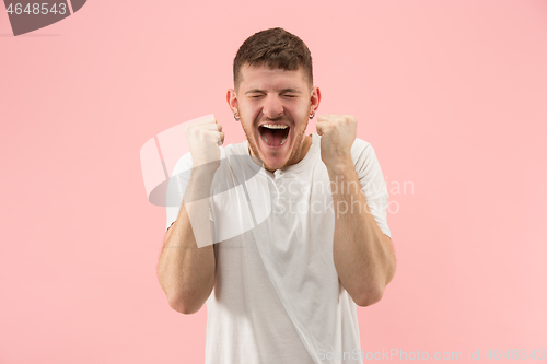 Image of Winning success man happy ecstatic celebrating being a winner. Dynamic energetic image of male model