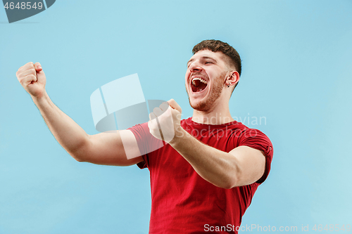 Image of Winning success man happy ecstatic celebrating being a winner. Dynamic energetic image of male model