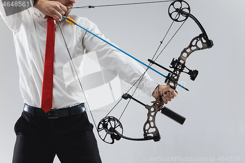 Image of Businessman aiming at target with bow and arrow, isolated on white background