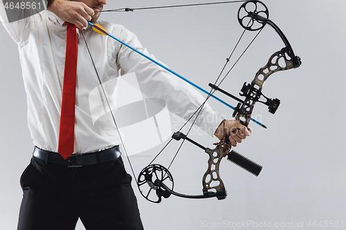 Image of Businessman aiming at target with bow and arrow, isolated on white background