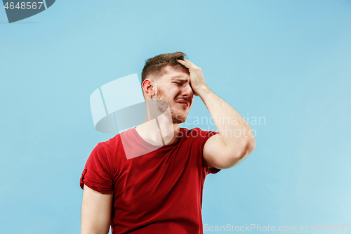 Image of Young boy with a surprised expression bet slip on blue background