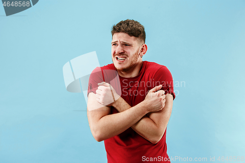 Image of Young boy with a surprised expression bet slip on blue background