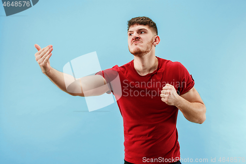 Image of Young boy with a surprised expression bet slip on blue background