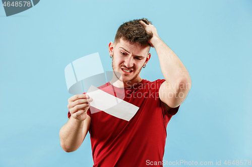 Image of Young boy with a surprised expression bet slip on blue background